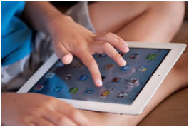 Kid on iPad following digital parenting tips